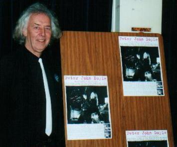 John with promotional CD posters